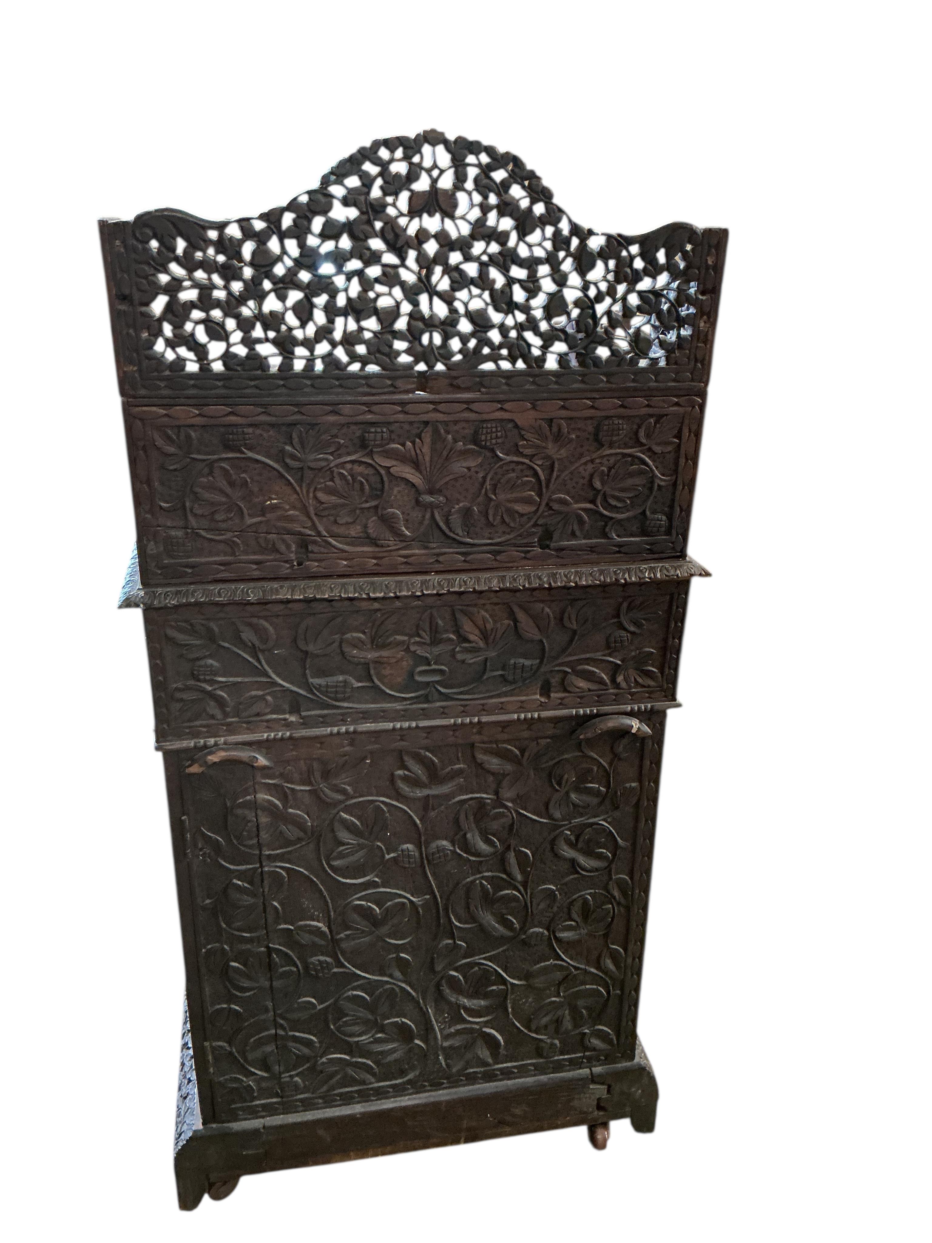 A 19th century Burmese carved hardwood Davenport, width 65cm, depth 67cm, height 122cm
